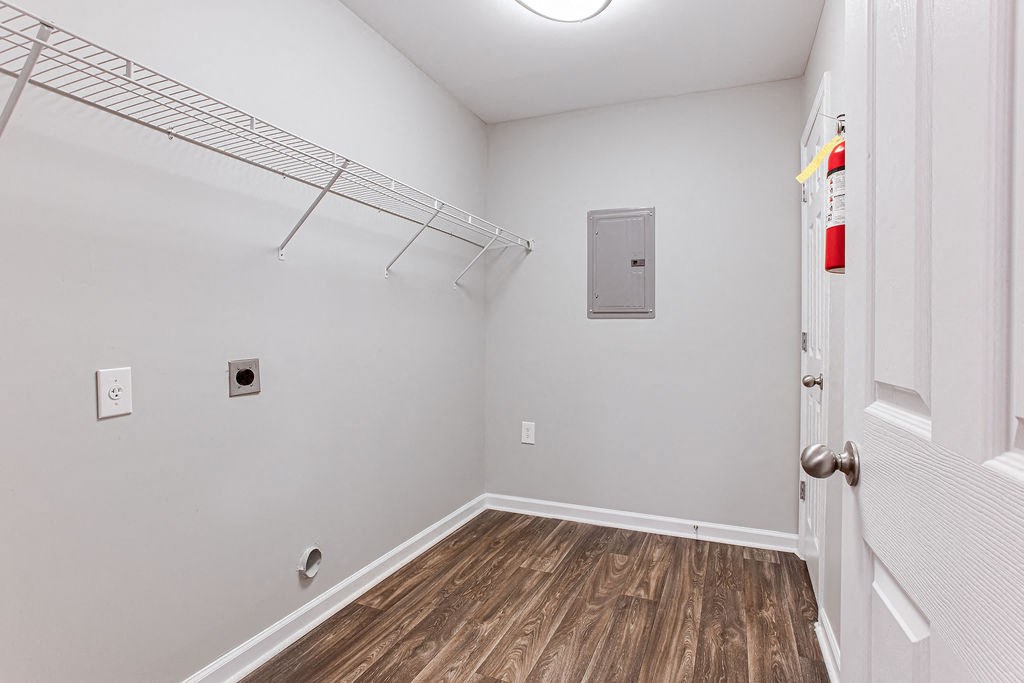 a white room with a closet and a door to a room with wood flooring at Magnolia Place at Stockbridge Apartments, Georgia, 30281