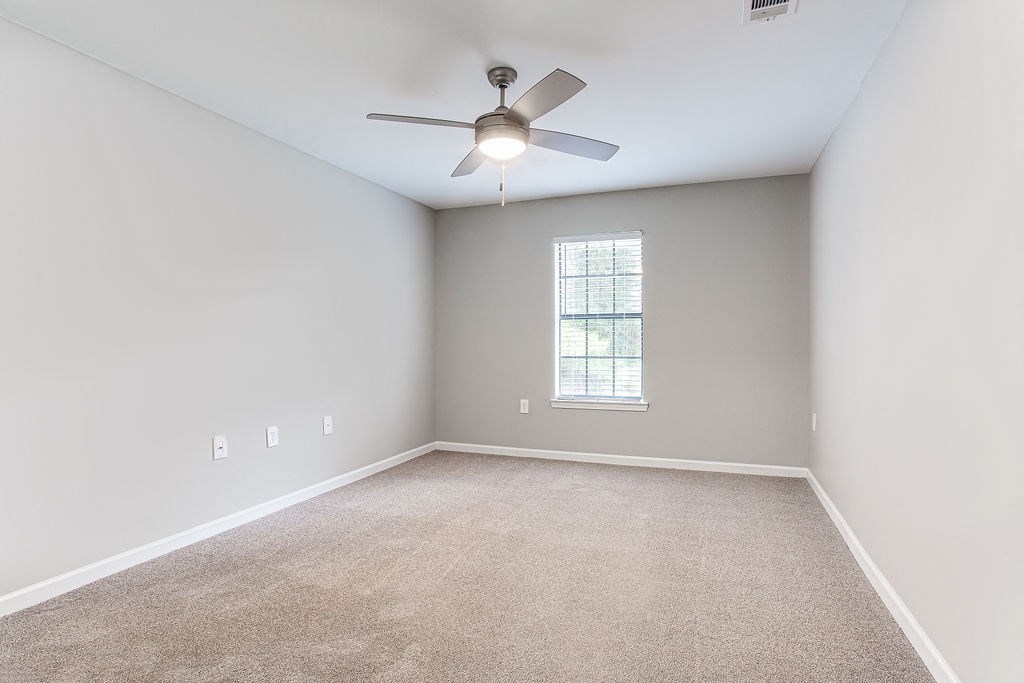 a ceiling fan and a window at Magnolia Place at Stockbridge Apartments, Stockbridge