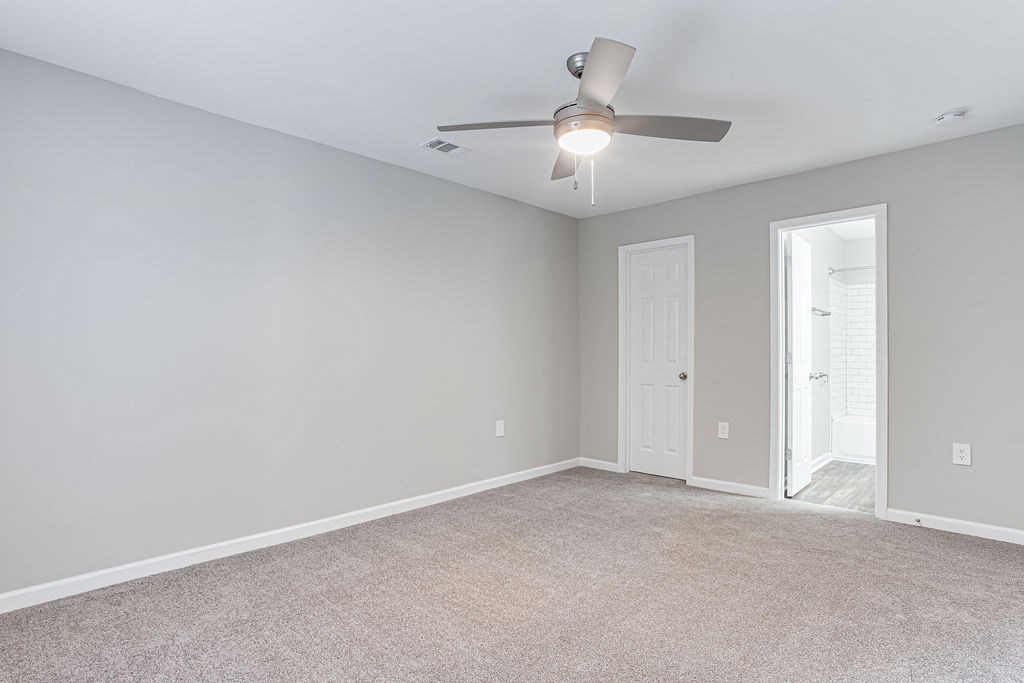 Unfurnished living room with a ceiling fan at Magnolia Place at Stockbridge Apartments, Georgia