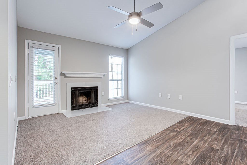 an empty living room with a fireplace at Magnolia Place at Stockbridge Apartments, Stockbridge, 30281