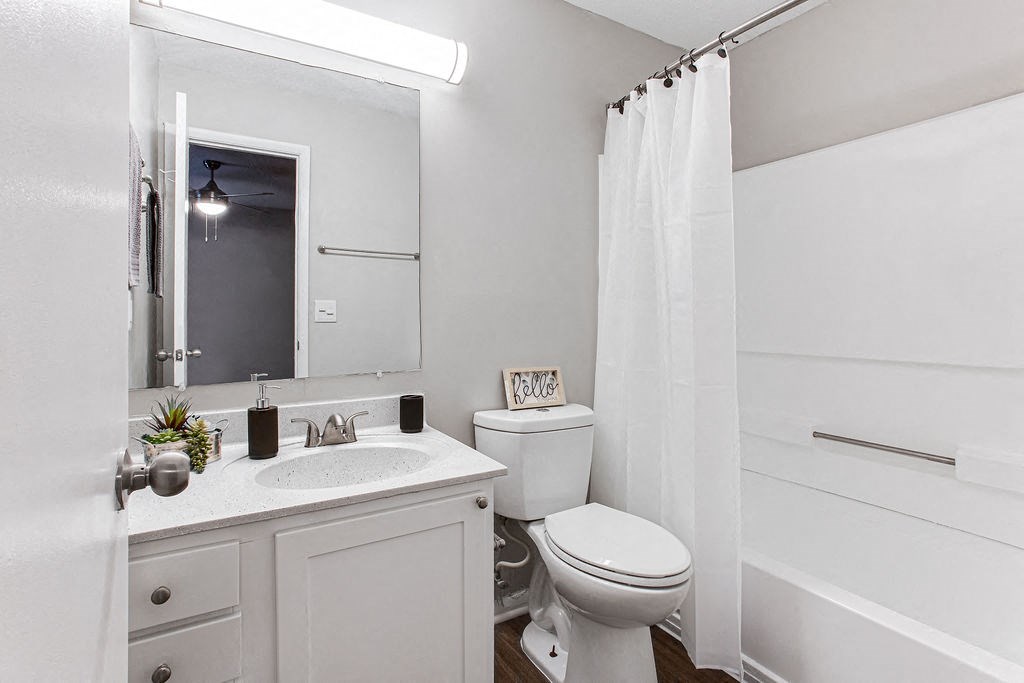 a bathroom with a toilet and a sink at Magnolia Place at Stockbridge Apartments, Stockbridge, 30281