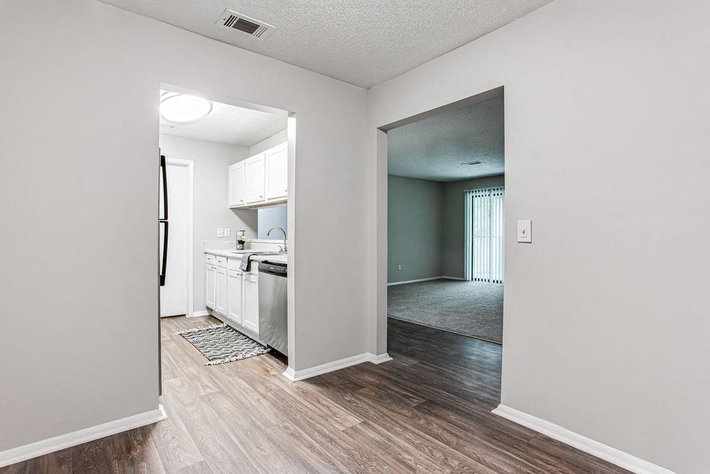 a view of a kitchen and living room from a doorway at Magnolia Place at Stockbridge Apartments, Stockbridge, GA
