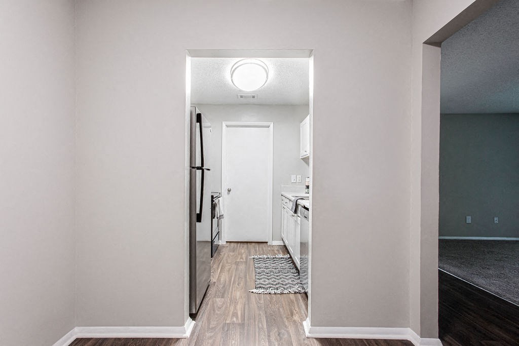 a view of a kitchen from doorway of dining room at Magnolia Place at Stockbridge Apartments, Stockbridge, Georgia
