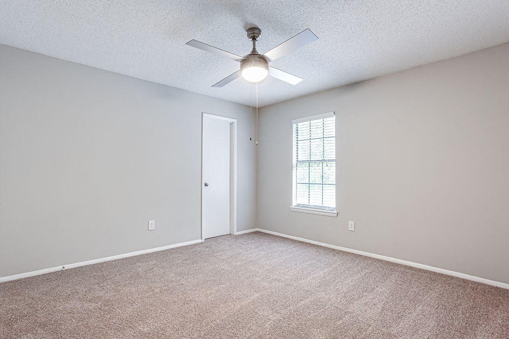 bed room with a ceiling fan and a window at Magnolia Place at Stockbridge Apartments, Stockbridge, GA, 30281