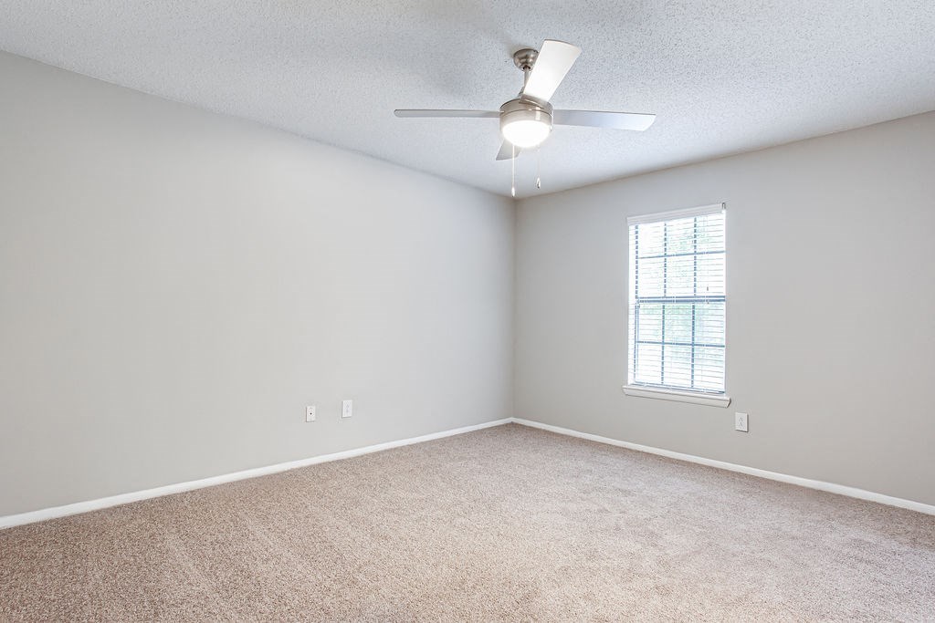 bedroom with a ceiling fan and a window at Magnolia Place at Stockbridge Apartments, Stockbridge, GA, 30281