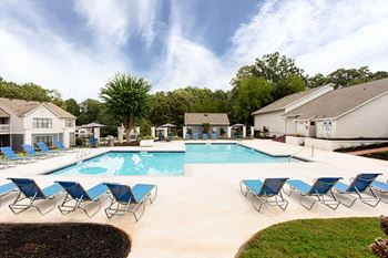 our apartments have a resort style pool with blue chairs