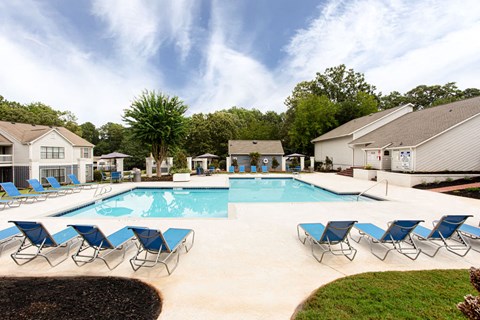 our apartments have a resort style pool with blue chairs at Magnolia Place at Stockbridge Apartments, Stockbridge, GA