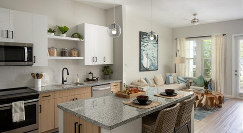 A modern kitchen with a dining table set for two.