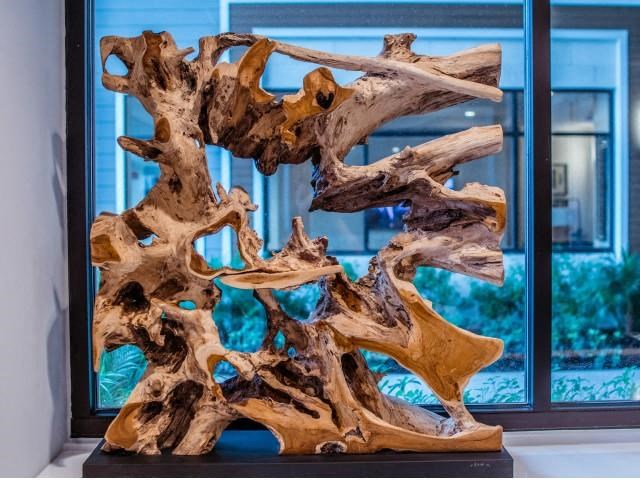 An artpiece of modern driftwood in front of a window at Lofts at South Lake, Clermont, FL