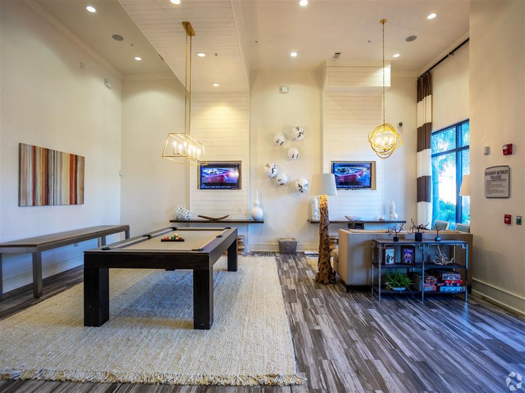 a game room with a pool table and a television