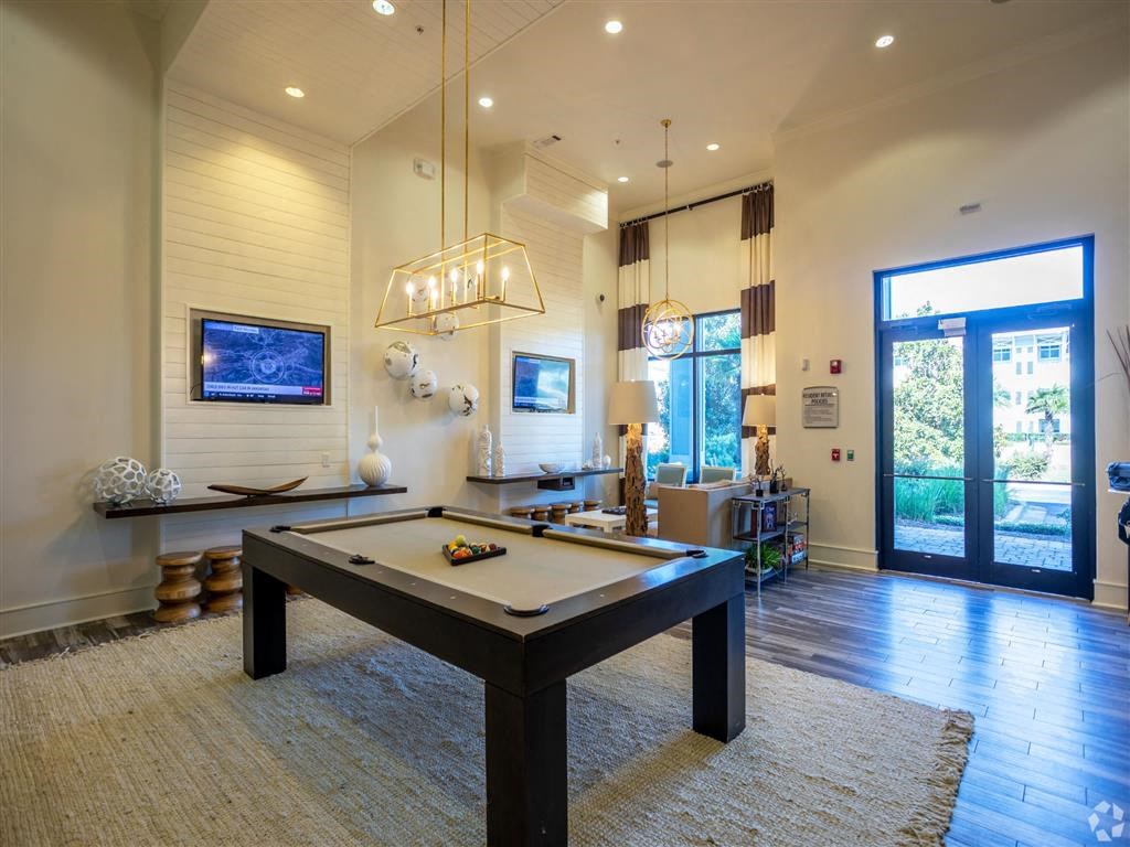 a pool table is in the center of a living room