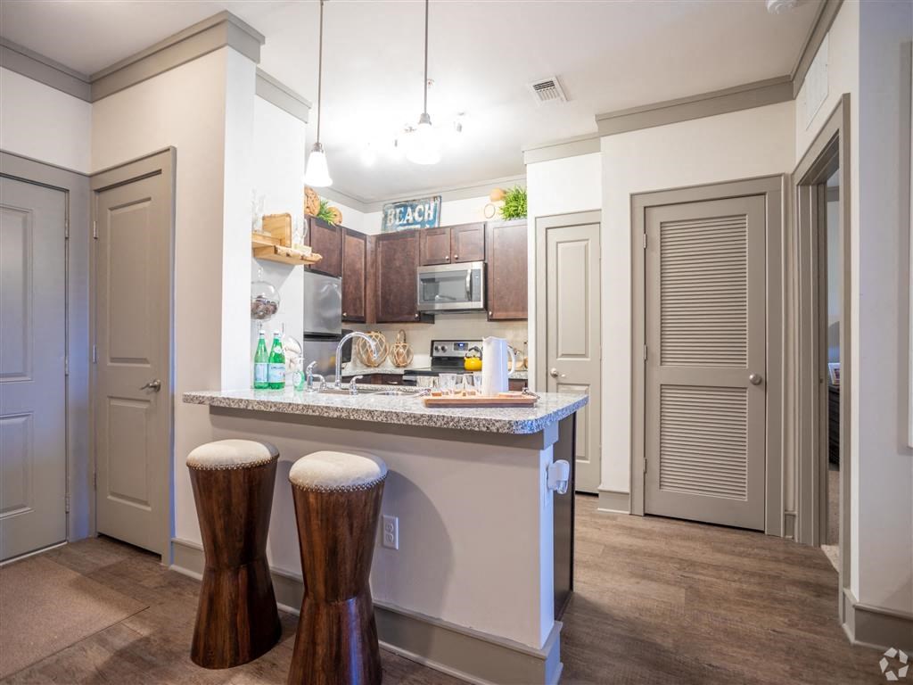 a kitchen with a counter top and some stools
