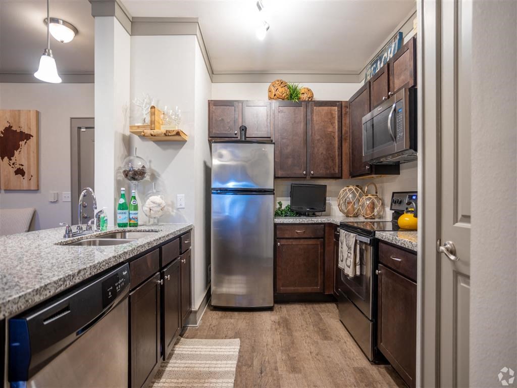 a kitchen with stainless steel appliances and granite counter tops