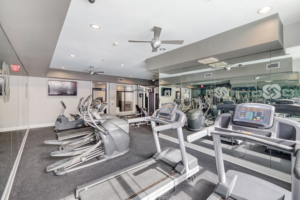 a gym with treadmills and other exercise equipment