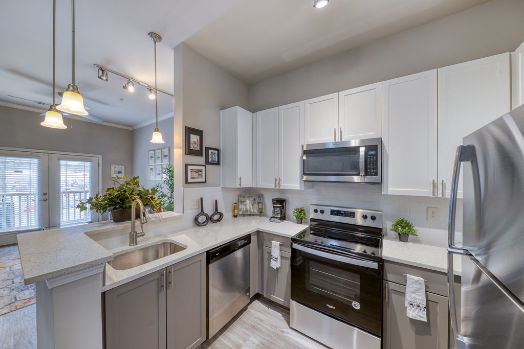 a kitchen with stainless steel appliances and white cabinets