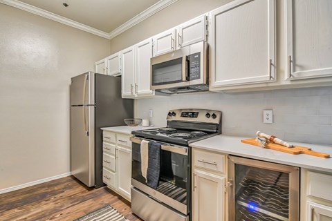 A kitchen with white cabinets and stainless steel appliances.