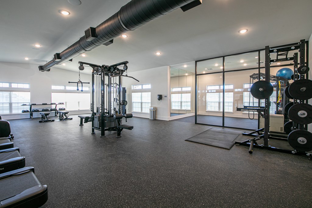 a fitness room with weights and other exercise equipment