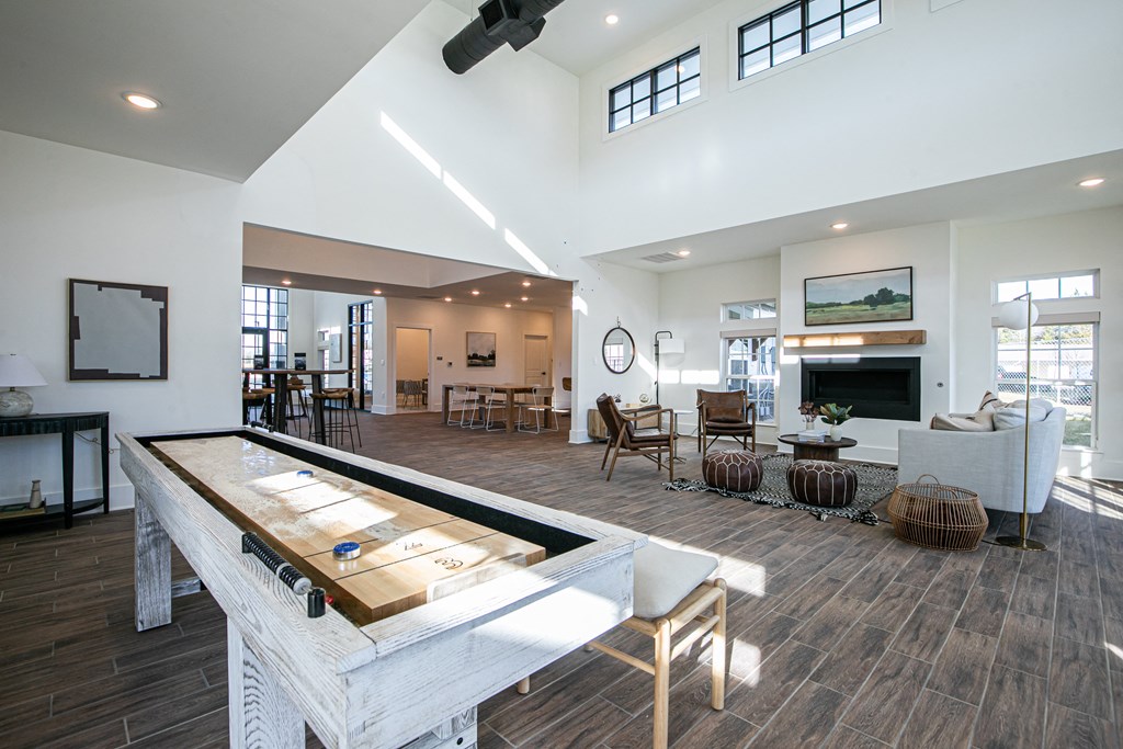 a large living room with a pool table in the middle