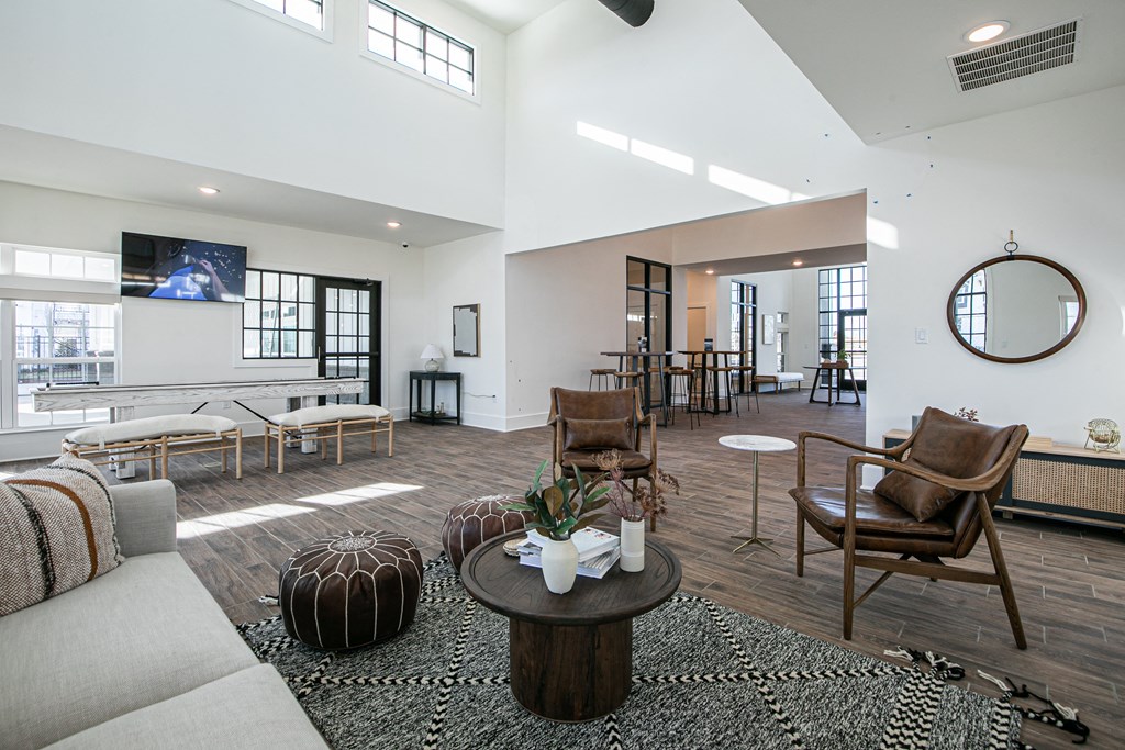 a living room with a couch and chairs and a table