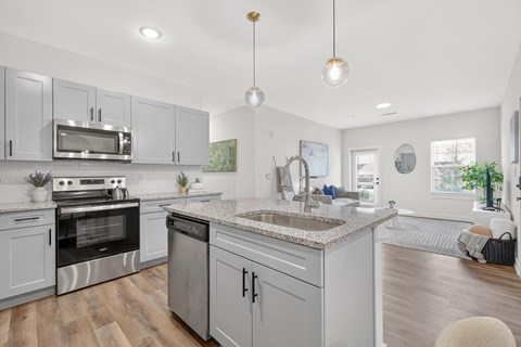 A modern kitchen with a stainless steel oven and microwave.
