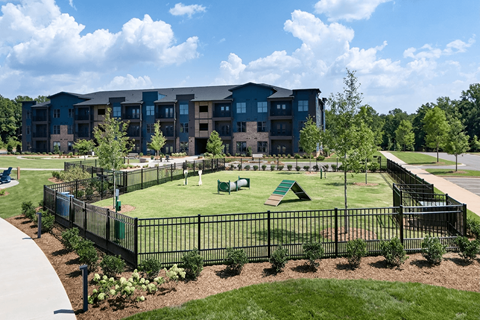 A large building with a green lawn in front.