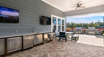 Outdoor Grill With Intimate Seating Area Outdoor Grill With Intimate Seating Area at Century Dunes, Deland, FL - Photo Gallery 5