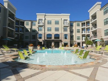 Sparkling pool with sundeck and lounge chairs 2370 Main at Sugarloaf apartments