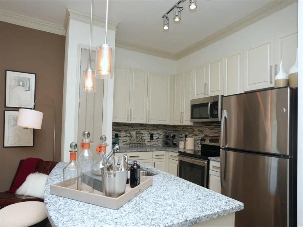 Modern kitchen with extended countertop at 2370 Main at Sugarloaf Duluth, GA