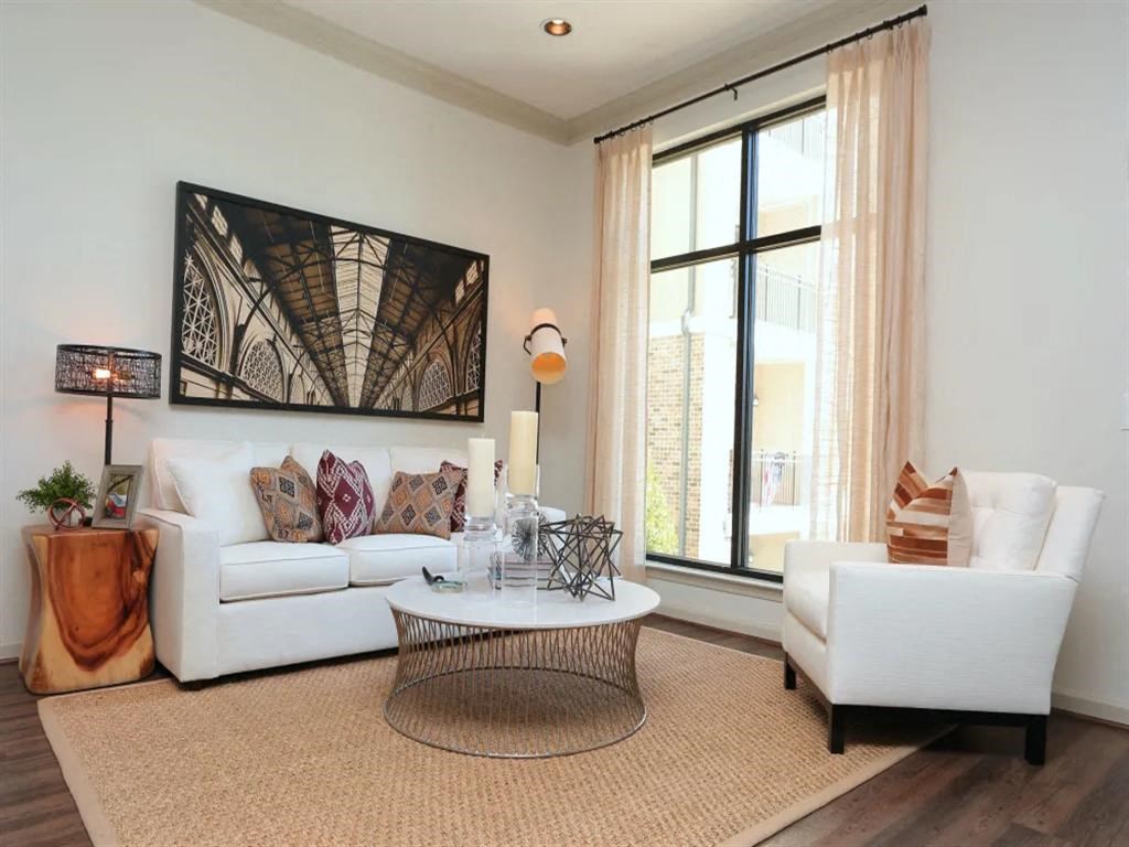 Spacious living room with hardwood flooring at 2370 Main at Sugarloaf Duluth, GA