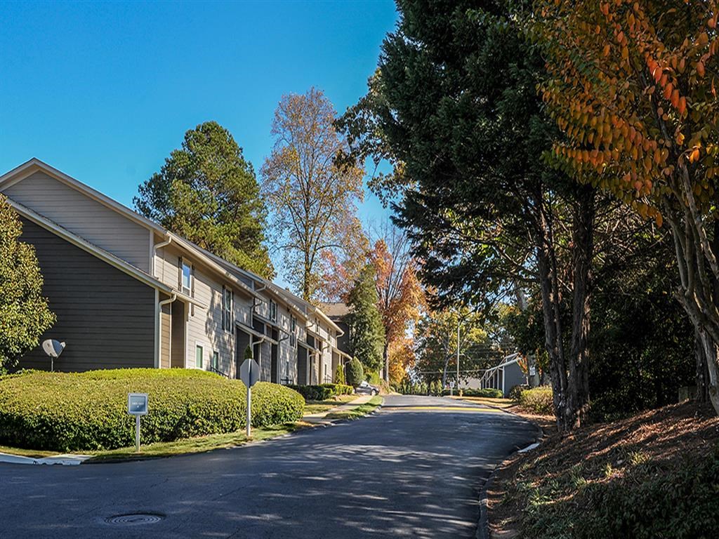 a street with houses and trees on either side at The Ellis Apartments, Clarkston, GA, 30021