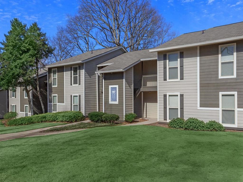 a grassy area with a building in the background at The Ellis Apartments, Clarkston, 30021