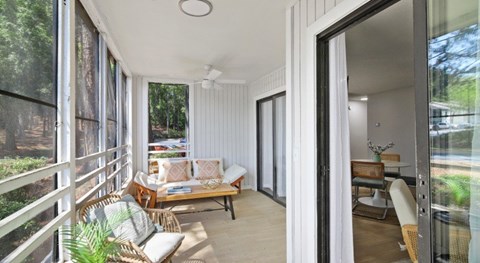 A sunny day in a modern house with a balcony.