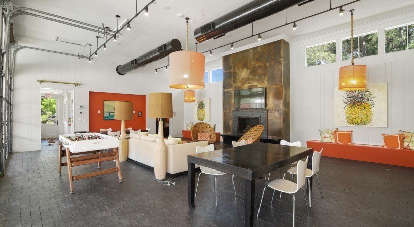 A modern kitchen with a dining table and chairs.