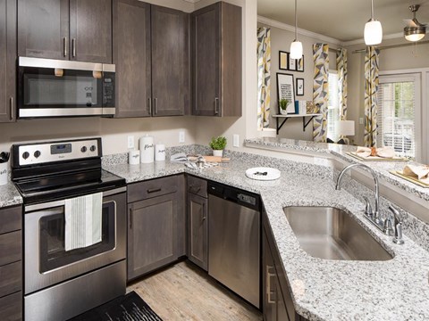 a kitchen with stainless steel appliances and granite counter tops