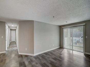 a living room with a sliding glass door to a balcony