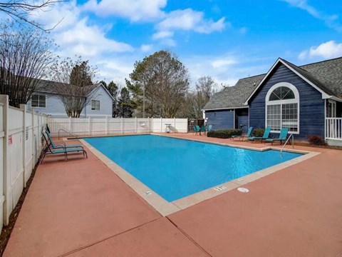 a swimming pool with a house and a fence around it at The Sapphire, Decatur, GA, 30035