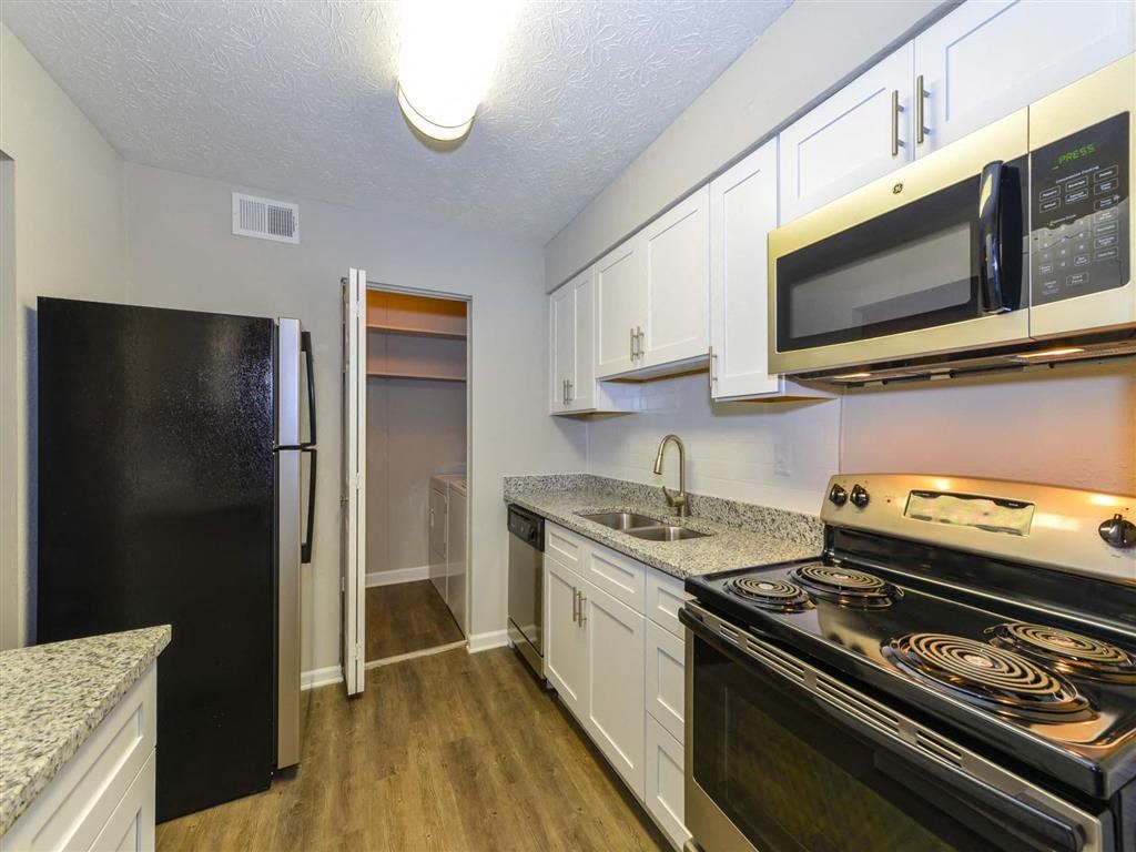 a kitchen with a stove microwave and refrigerator