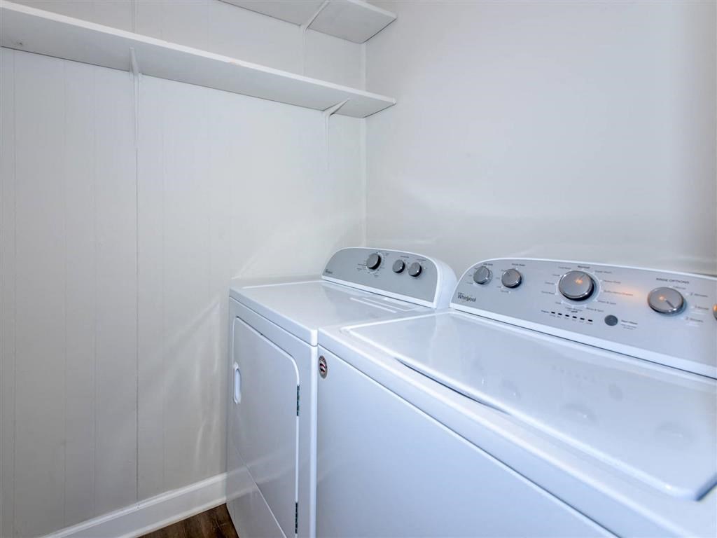 a laundry room with two washes and a dryer