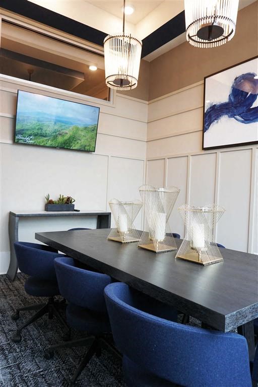 a dining room table with blue chairs