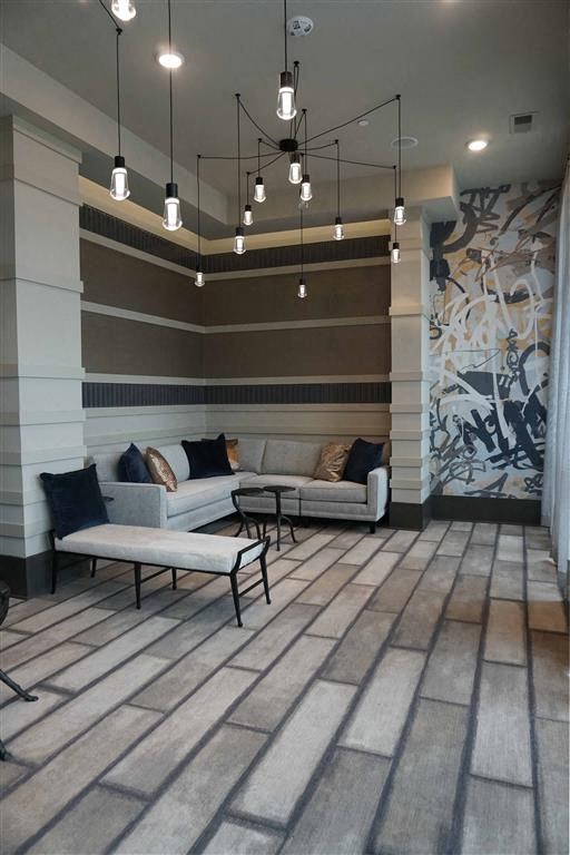 a lobby with couches and tables and lights