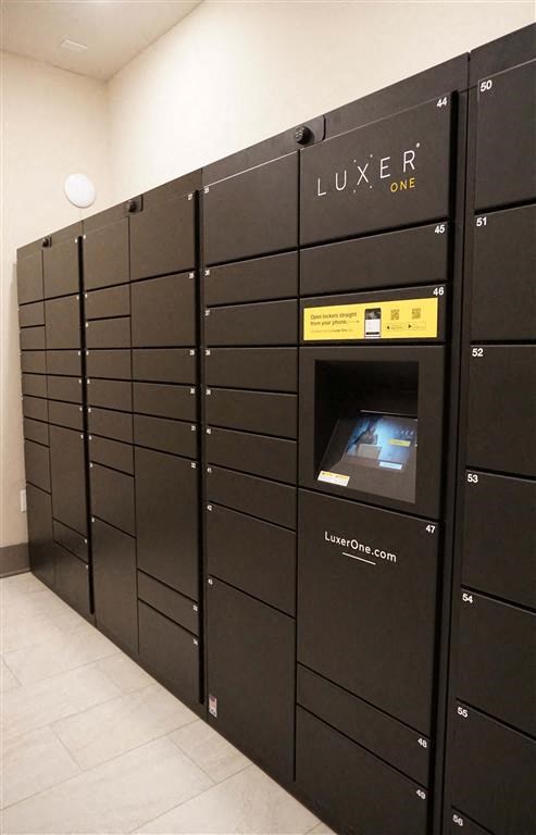 a bunch of lockers in a room with a coin machine