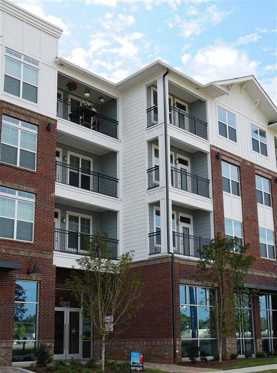 an apartment building with red brick and white walls