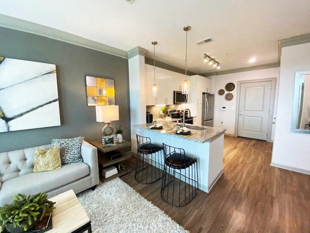 a living room and kitchen with a couch and a table