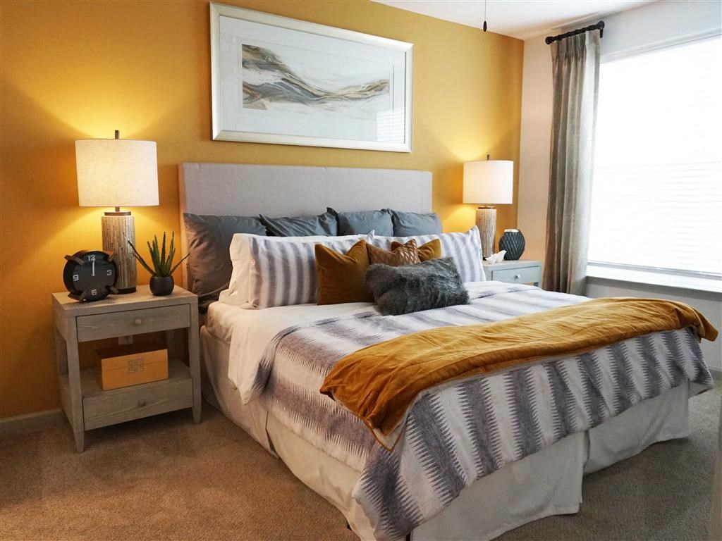 a bedroom with a bed and two lamps