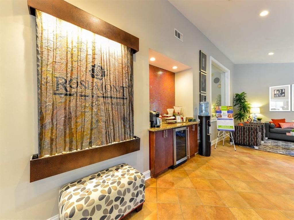 a lobby with a bar and a painting on the wall