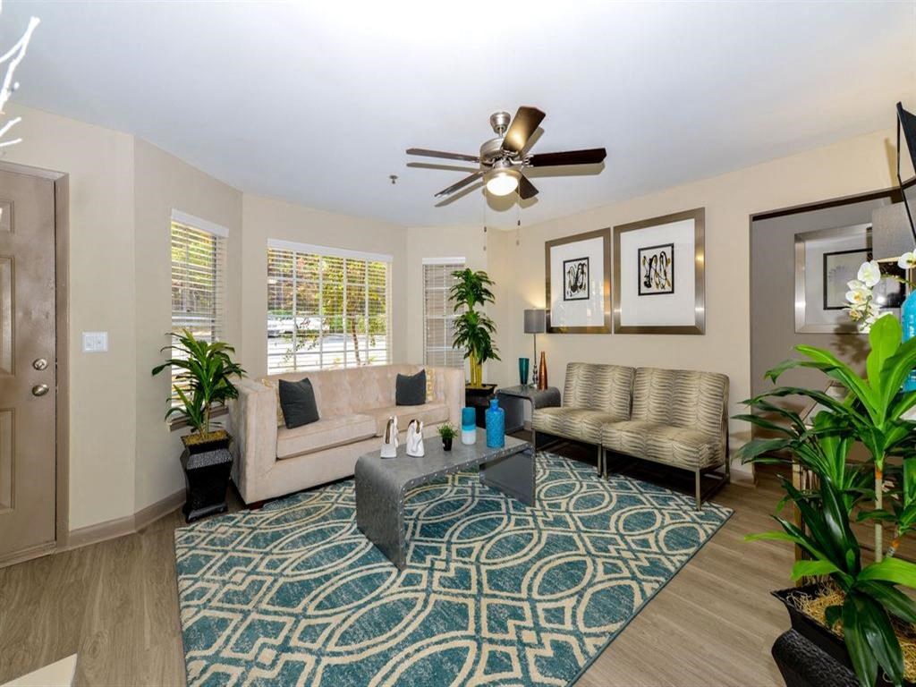 a living room with a couch and a ceiling fan