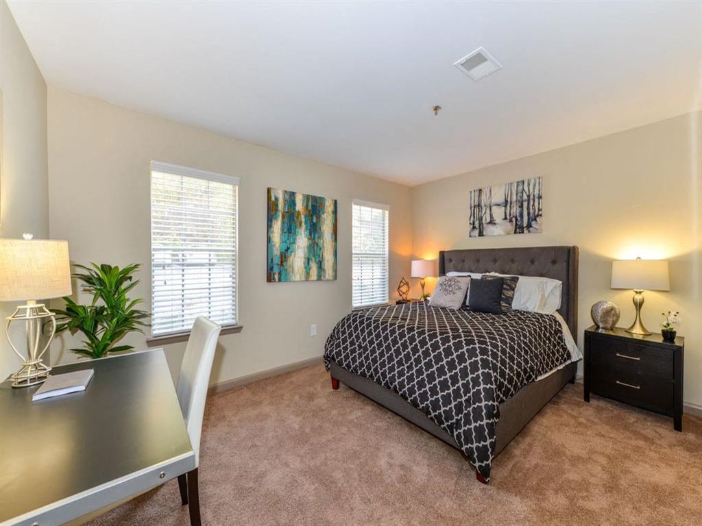 a bedroom with a bed and a desk