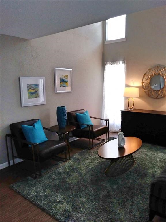 a living room with two chairs and a table