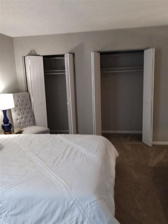 a bedroom with a white bed and a closet