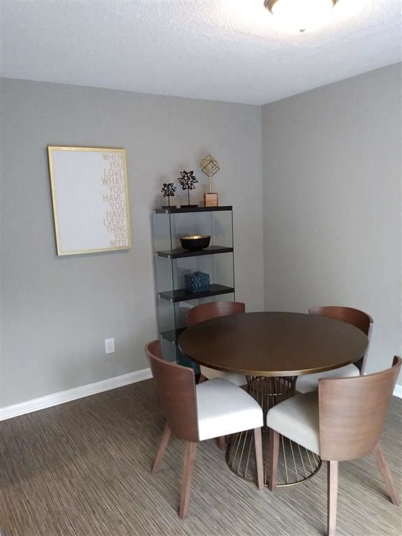 a dining room with a table and chairs